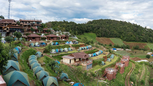 High angle view of houses and trees against sky