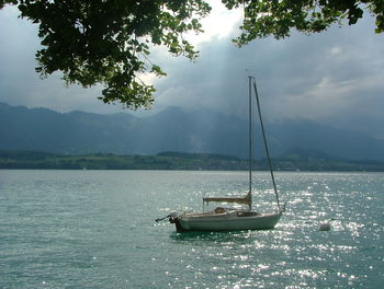 Boat sailing on lake against sky