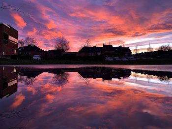 Scenic view of lake against romantic sky at sunset