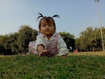 Portrait of baby girl sitting in park