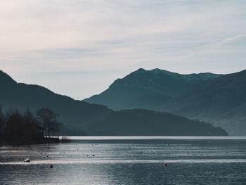 Scenic view of lake and mountains against sky