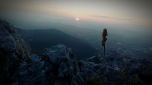 Scenic view of mountain against sky at sunset