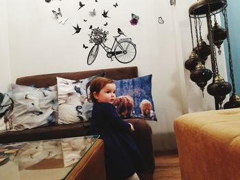 Girl sitting on sofa at home