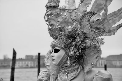 Close-up of woman wearing costume against sky