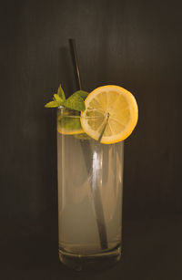 Close-up of drink on table against black background