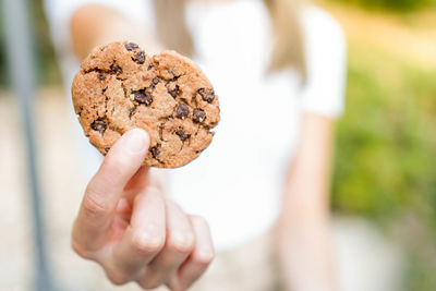 Cropped hand of person holding cookies