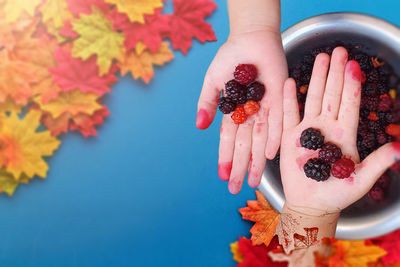 Midsection of woman holding berries