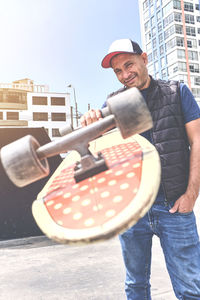Portrait of young man standing against wall