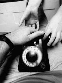 High angle view of hands holding mobile phone