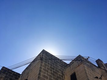 Low angle view of buildings against blue sky