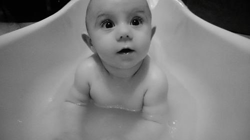 Close-up of cute baby girl in bathroom