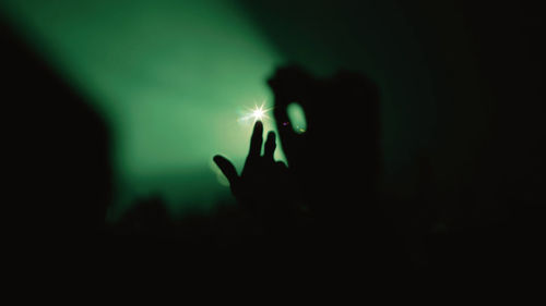 Silhouette hand of person at nightclub