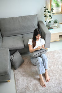 Young woman using laptop at home
