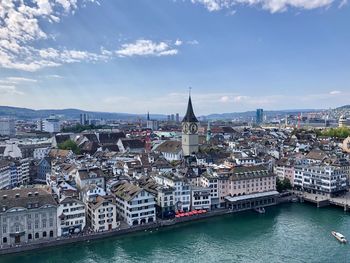River amidst buildings in city against sky