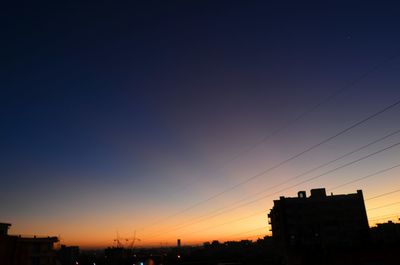 Low angle view of buildings against sky at sunset