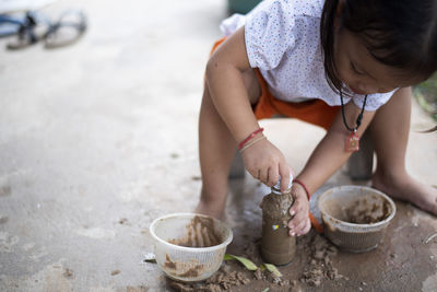 High angle view of woman holding sand