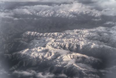 Scenic view of mountains against cloudy sky