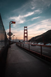 View of suspension bridge against cloudy sky