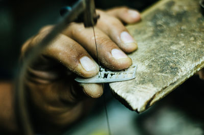 Close-up of hand making art and craft product