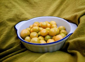 Winter cherries in container on fabric