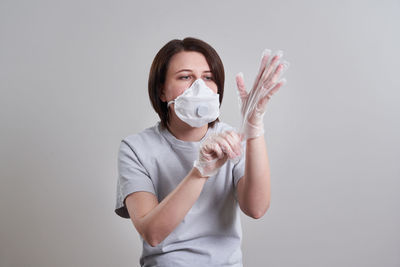 Woman standing against white background