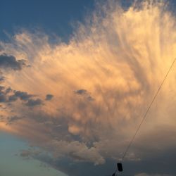 Low angle view of silhouette cables against sky during sunset