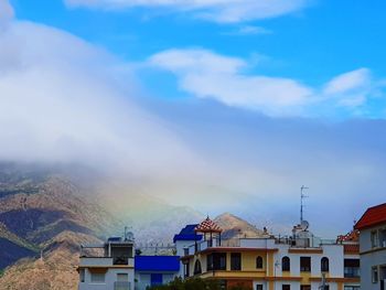 Buildings in town against sky