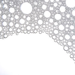 Close-up of bubbles over white background