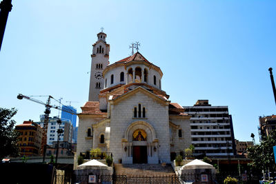 Low angle view of church against clear sky in city