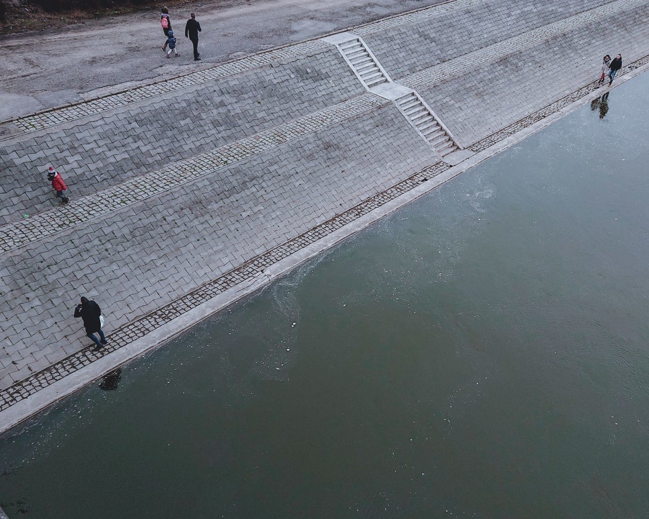 HIGH ANGLE VIEW OF PEOPLE WALKING ON STREET DURING RAINY SEASON