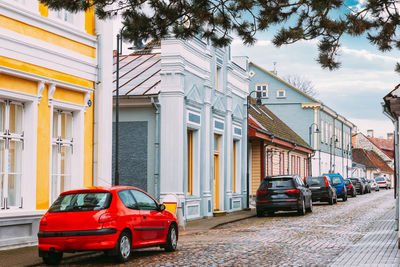 Cars on street by buildings in city