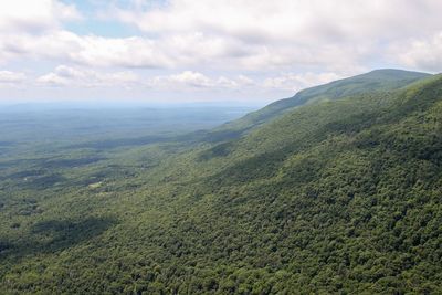 Scenic view of mountains against cloudy sky