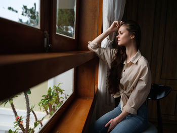 Side view of young woman sitting on staircase