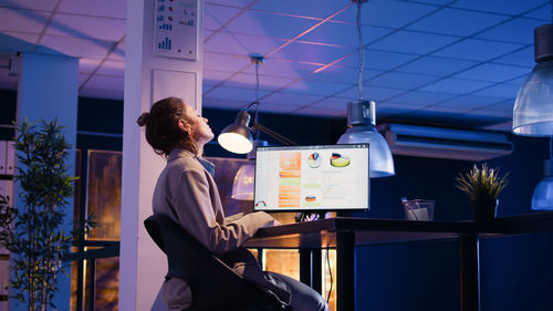 Rear view of woman sitting in cafe