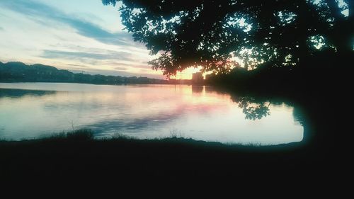 Scenic view of calm lake at sunset