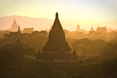 Temples at bagan archaeological zone against sky during sunset