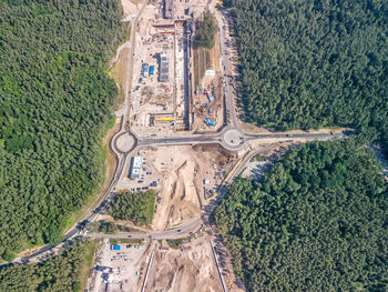 High angle view of road amidst trees on field