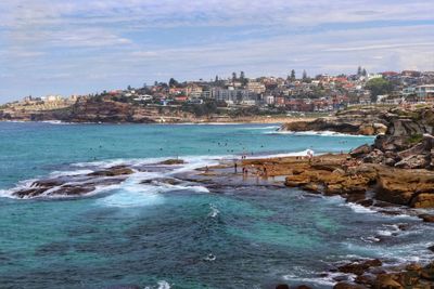 Scenic view of sea and buildings against sky