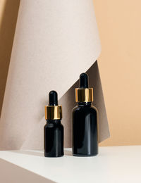 Brown glass bottle with pipette stands on a white table. cosmetics spa branding. packaging 