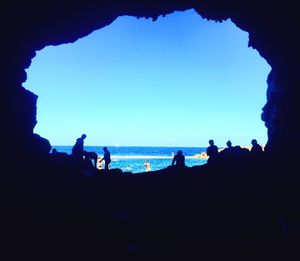 Silhouette of people in sea