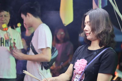 Young woman holding incenses