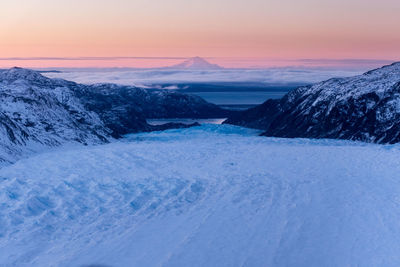 Scenic view of snowcapped mountains against sky during sunset