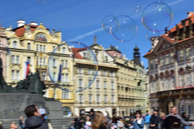 People in city against sky