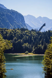 Scenic view of lake and mountains against clear sky