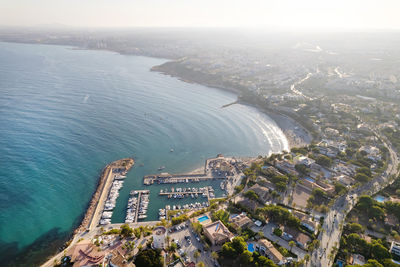 High angle view of buildings by sea against sky