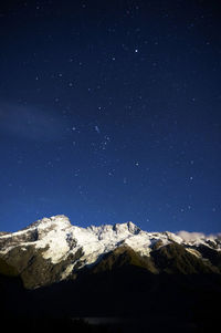 Low angle view of mountain against clear sky at night