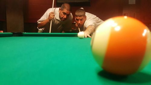 Friends playing pool in hall