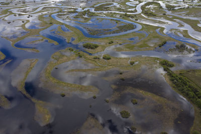 Aerial view of winding flooded river beds with ducts, during the spring flood. drone view.