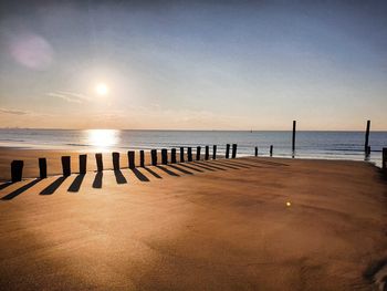 Scenic view of beach against sky during sunset