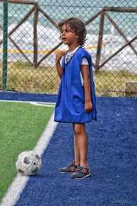 Full length of girl standing on white wall